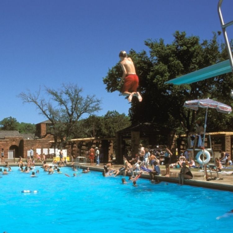 Going off the high dive at Abilene State Park's swimming pool